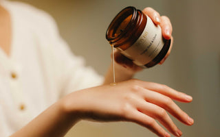 Benefits a woman pouring a jar of melted moisturizing candle
